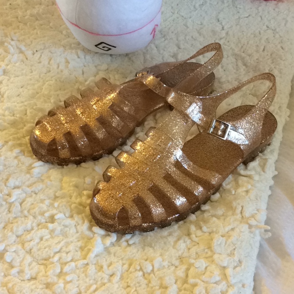 Gold sparkly jelly sandals.